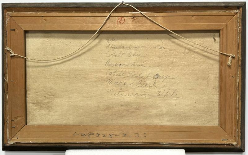 The back of a framed canvas painting is shown, revealing its wooden stretcher bars and a taut hanging wire attached with screws on either side. The canvas has handwritten notes in pencil listing various paint colors, including "Cobalt Blue," "Prussian Blue," "Mars Black," and "Titanium White." A red stamp mark is visible near the top center of the frame. The edges of the frame appear slightly worn, showing signs of age and use. A number, "LWP 528-3-31," is written along the bottom wooden bar.