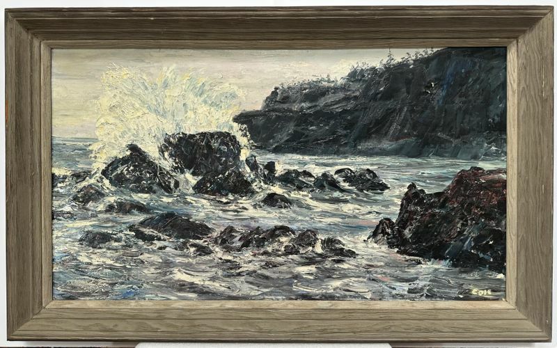 A framed oil painting of a coastal scene depicting waves crashing against jagged rocks. The painting features a dynamic and textured impasto technique, with dark cliffs in the background and foamy white spray from the waves.