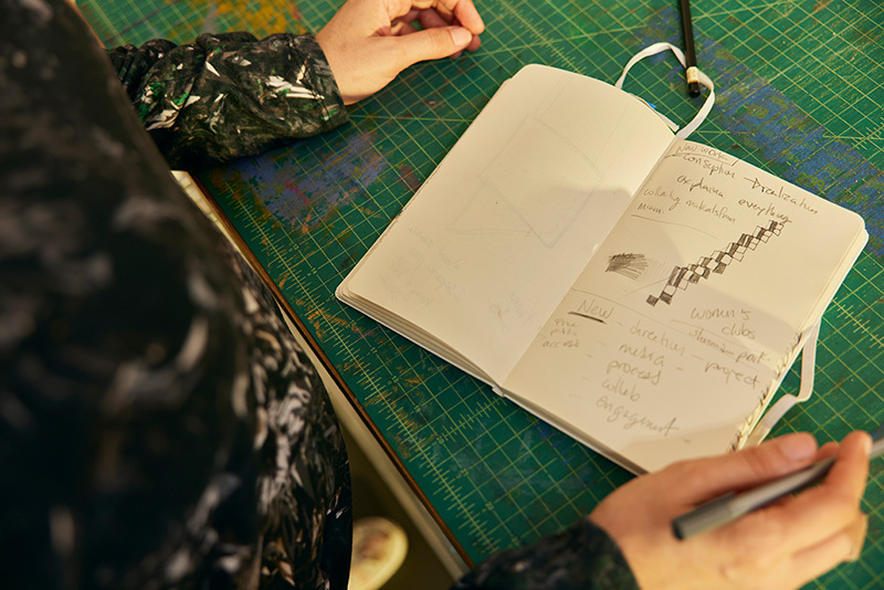 Regina Jestrow writing in her notebook