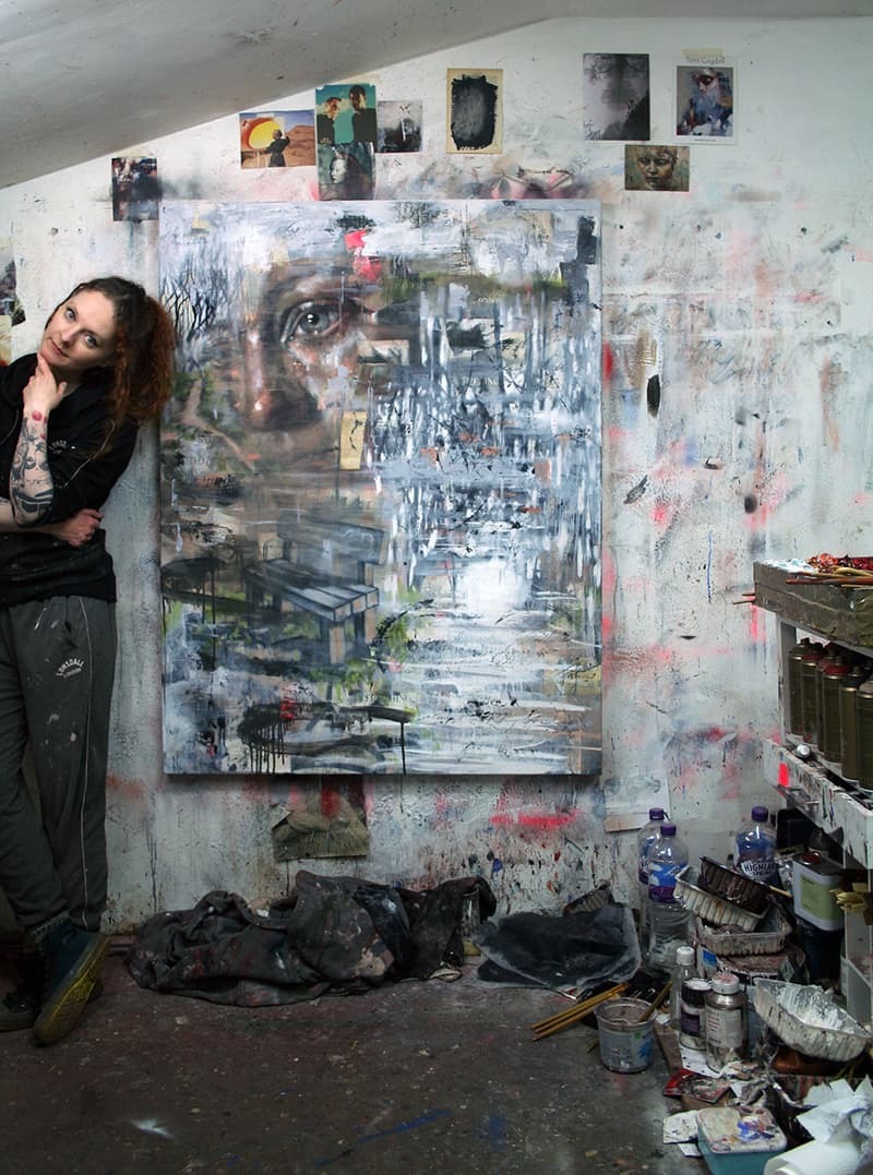 Artist Toni Cogdell in front of one of her paintings